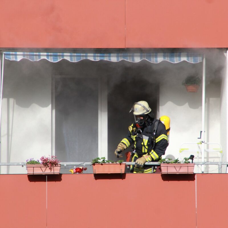 Firefighter putting out an apartment fire