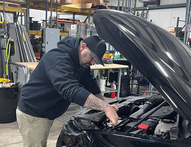 Josh Knauer working on a vehicle