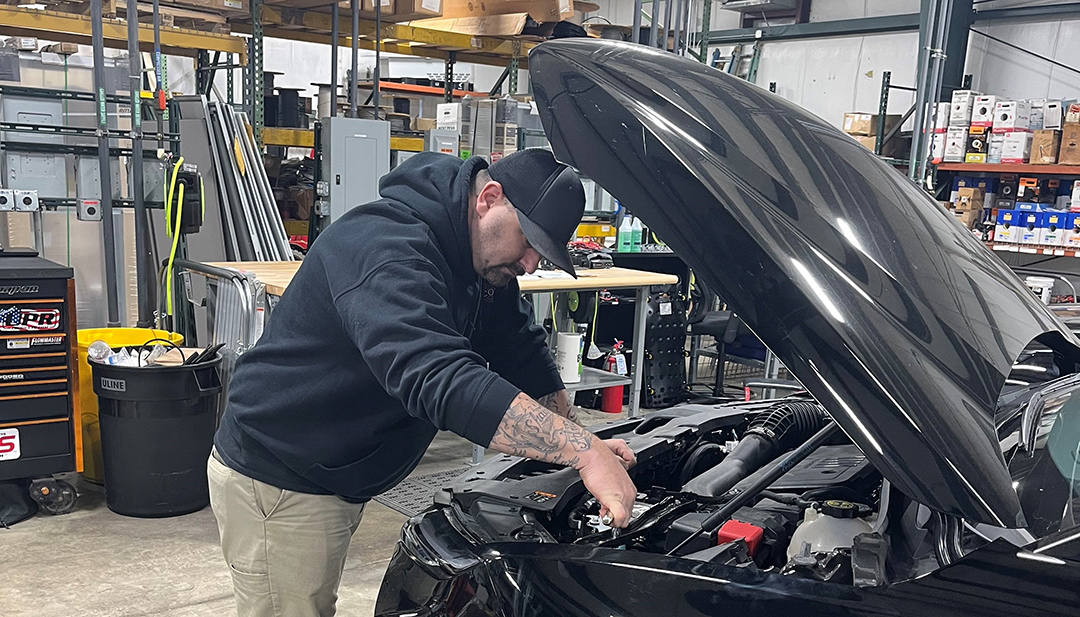 Josh Knauer working on a vehicle