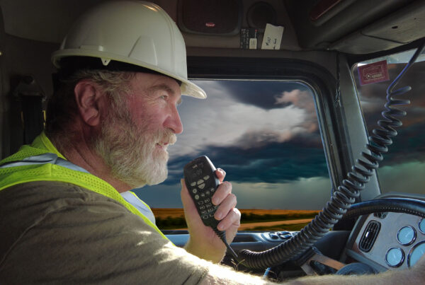 Heavy vehicle driver using a dispatch radio while driving