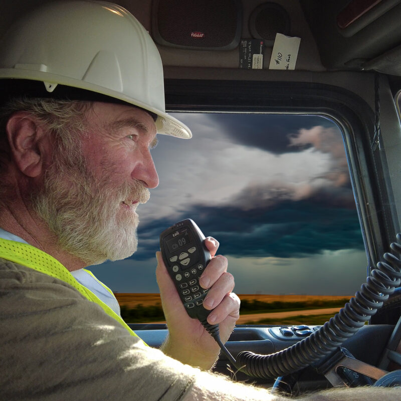 Heavy vehicle driver using a dispatch radio while driving