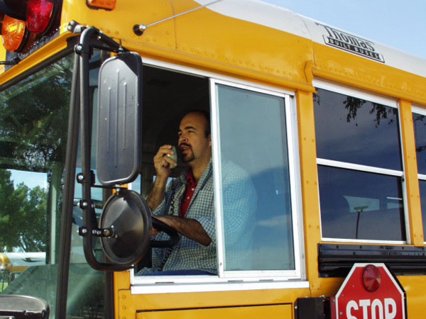 Bus driver using a dispatch radio while driving