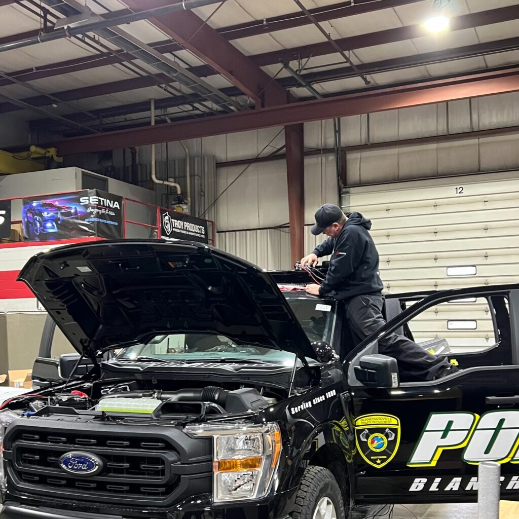 GenComm Employee Wiring a Police Truck