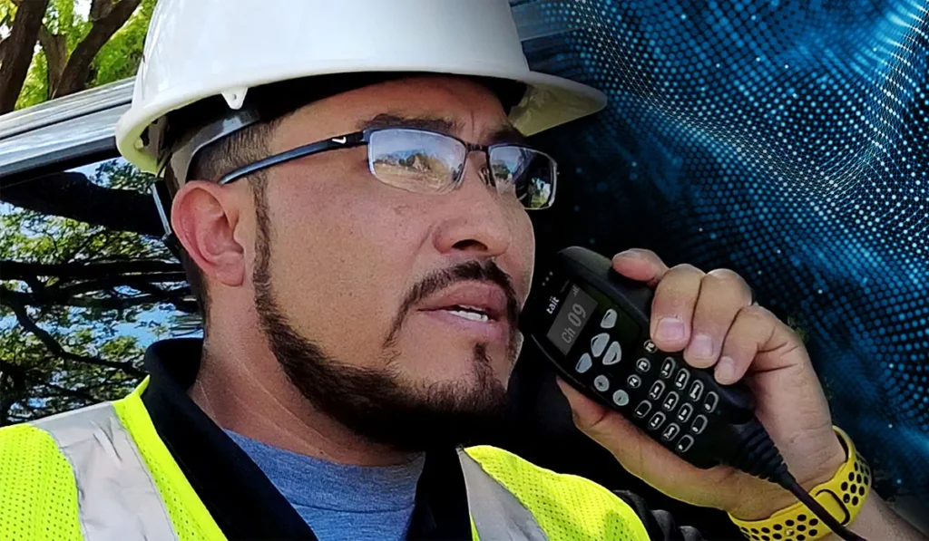 construction worker using Tait radio for safer construction site communication