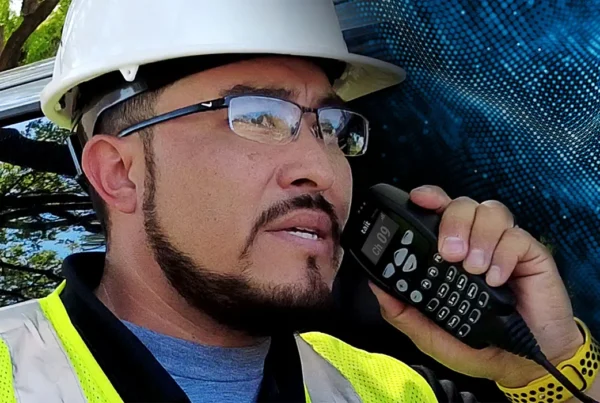 construction worker using Tait radio for safer construction site communication
