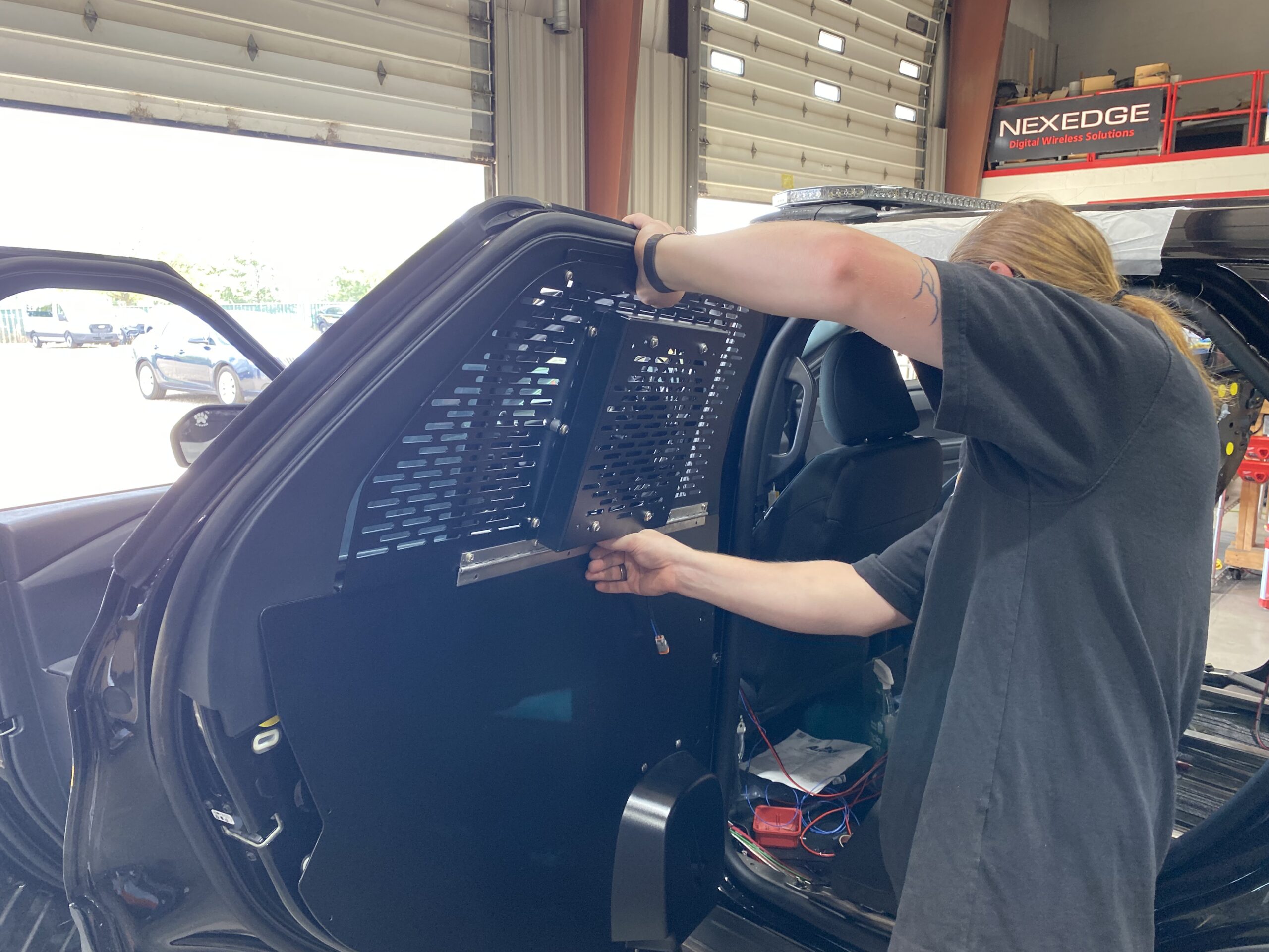 installing a shield on a police vehicle for faster response times and better protection and communication